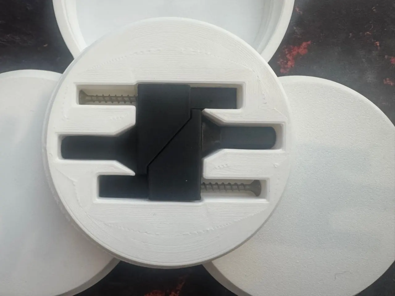 Black ABS parcel shelf hinge components fully exposed inside the opened white rotating packaging