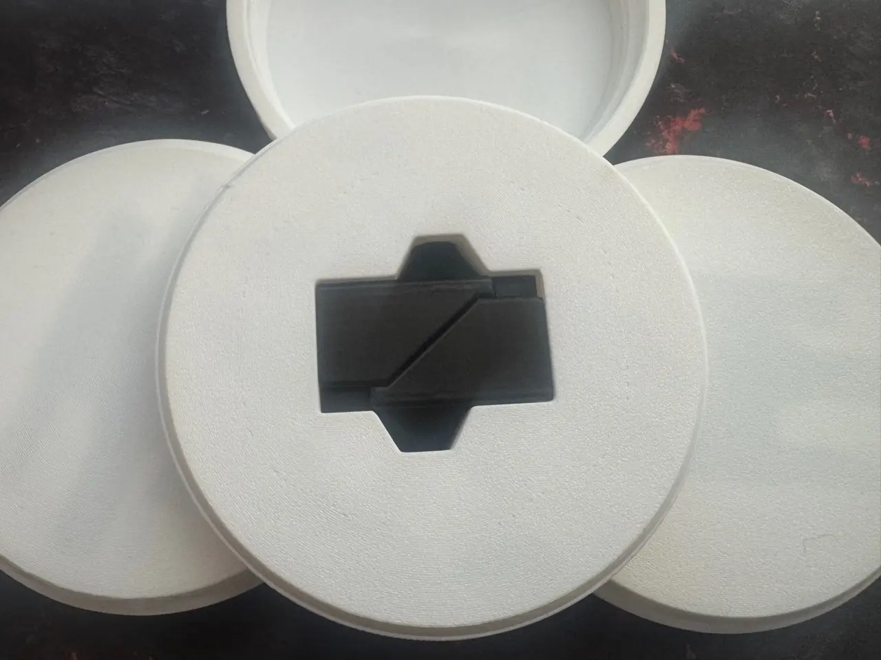 Back of the opened parcel shelf hinge packaging showing the push-through removal opening